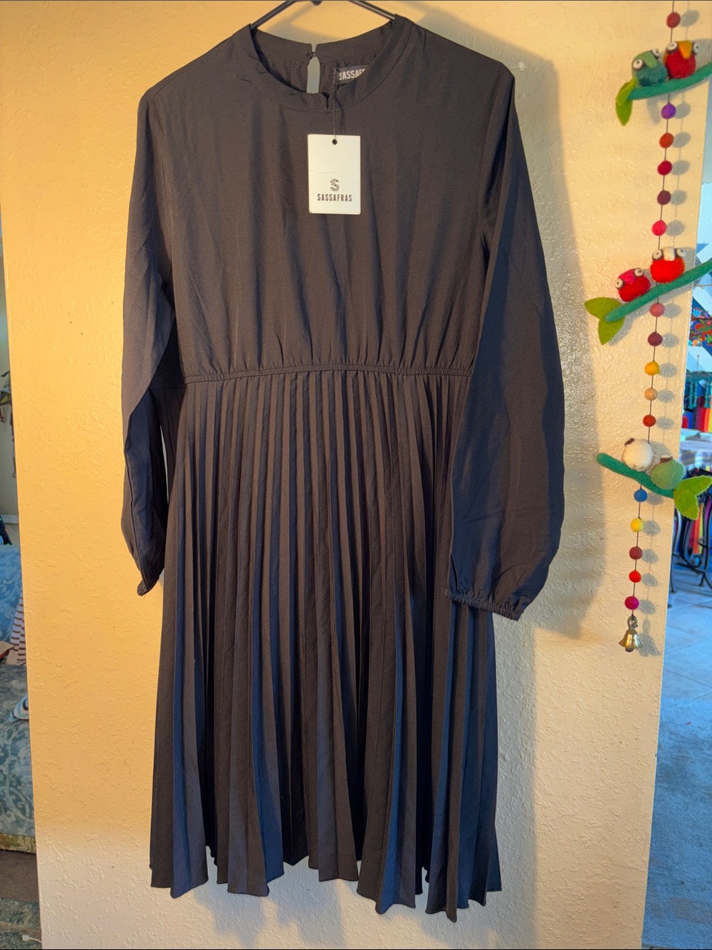 NWT SASSAFRAS black pleated dress features a stand collar and long balloon sleev